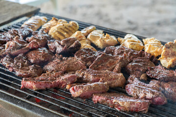 Barbecued Steak and Chicken on a Smoky Grill in a Ranch in Santa Cruz Chile