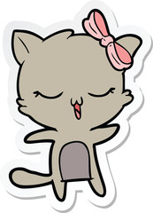 sticker of a cartoon cat with bow on head