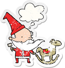 cartoon santa making toy and thought bubble as a distressed worn sticker