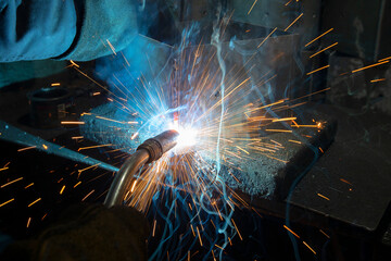 Fototapeta na wymiar Industrial steel welder in a factory. Welder at work.