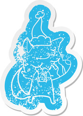 crying fox cartoon distressed sticker of a wearing santa hat