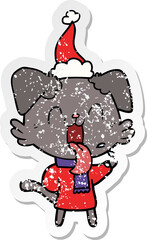 distressed sticker cartoon of a panting dog wearing santa hat
