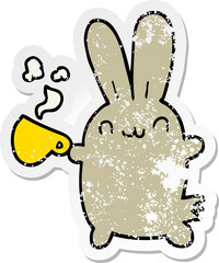 distressed sticker of a cute cartoon rabbit drinking coffee