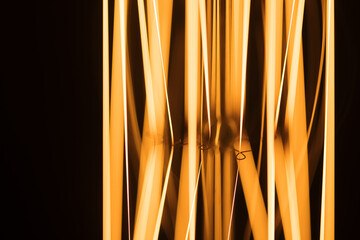 Tungsten filament of a lamp glowing in dark, macro photo background