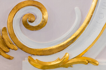 White gypsum bas-relief with gold colored details, wall design, rococo