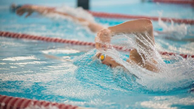 Cinemagraph. Swimmer swims freestyle swimming style in the pool.