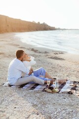 Happy romantic middle aged couple on the beach. Picnic by the sea. Travel vacation retirement lifestyle concept