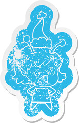 happy alien girl cartoon distressed sticker of a wearing santa hat