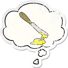 cartoon knife spreading butter and thought bubble as a distressed worn sticker