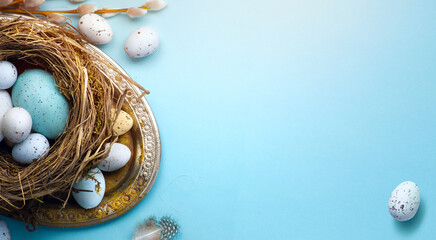 Easter greeting card or banner background with Easter eggs and spring flowers on blue table