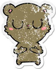 distressed sticker of a peaceful cartoon bear cub