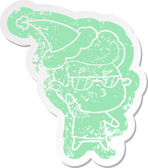 cartoon distressed sticker of a cool guy wearing santa hat