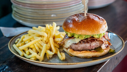 freshly grilled Guacamole beef burger and French Fries 