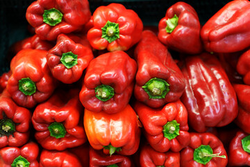 Red bell peppers background. Peppers on the counter of a vegetable farm eco market