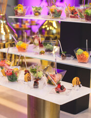 Beautifully decorated banquet catering table with variety of different food snacks, sandwiches, croissants and appetizers on a party event or celebration, delicatessen setting, coffee break