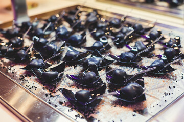 Beautifully decorated banquet catering table with variety of different food snacks, sandwiches, croissants and appetizers on a party event or celebration, delicatessen setting, coffee break