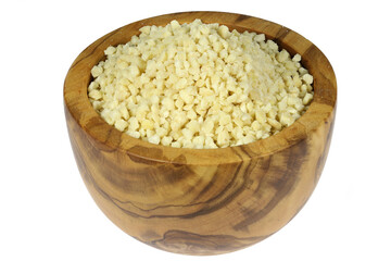 chopped almonds in an olive wood bowl isolated on white background