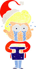 retro cartoon of a crying man holding book wearing santa hat