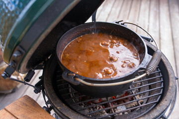 ready to eat - goulash from venison meat, from a chamois -  cooked in a dutch oven on a charcoal grill at outdoor