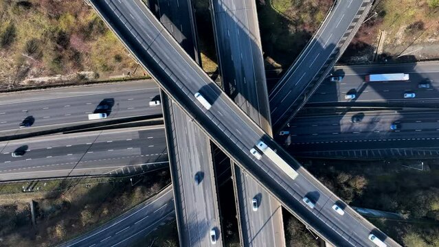 Vehicles Driving Along a Busy Motorway Interchange in the UK Aerial View