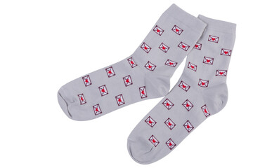 A pair of gray socks with a pattern of many postal envelopes, on a white background, isolate