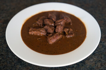 ready to eat - goulash from venison meat served on a white plate