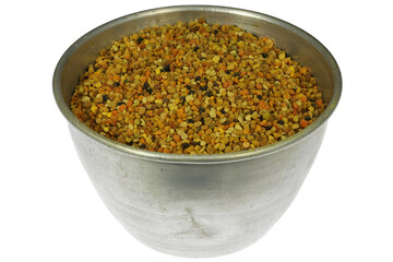 organic bee pollen in an aluminum bowl isolated on white background