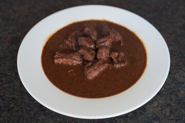 ready to eat - goulash from venison meat served on a white plate