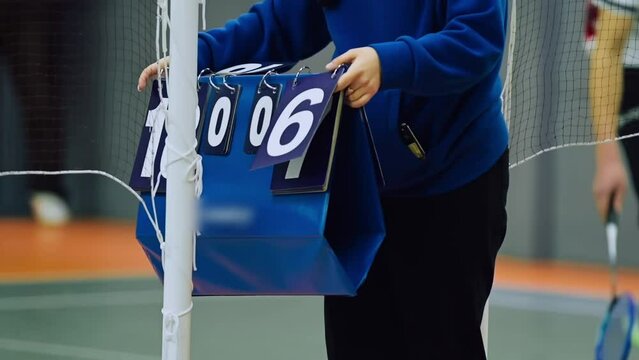 Tennis scoreboard, referee changes the score manually.