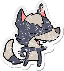 distressed sticker of a cartoon wolf laughing