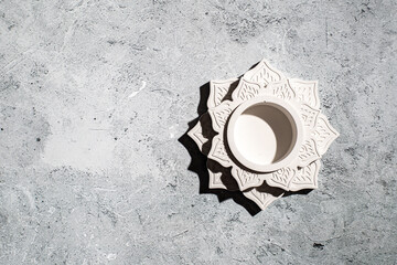 Photos of a handmade plaster candlestick in the shape of a lotus
