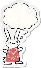 cute cartoon rabbit and thought bubble as a distressed worn sticker