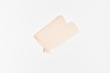 One cosmetic touch of foundation. Perfection of the skin. The concept of beauty, cosmetology and makeup. Design template, poster for advertising. Highlighted on white. Copy space. High quality photo