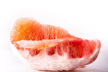 Pomelo on a white background.Advertising pomelo.Grapefruit.Pomelo pink. Fruit isolated.Cut pomelo on white background.Pomelo macro shot.Grapefruit macro shot.Juice drops on the fruit. fruit macro shot