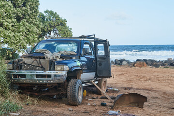 Stolen and stripped pick-up truck wreck dumped at a beach on Kauai, Hawaii