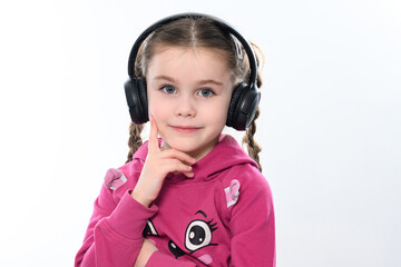 A girl on a white background with headphones on her head.