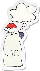 cartoon bear wearing christmas hat and thought bubble as a distressed worn sticker