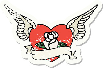 traditional distressed sticker tattoo of a flying heart with flowers and banner