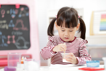 young girl playing Science experiment toys for homeschooling