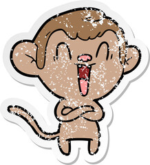distressed sticker of a cartoon laughing monkey