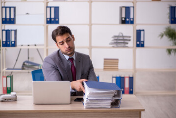 Young male employee working in the office