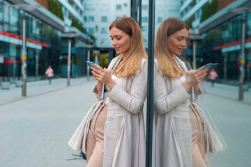 Business woman using smart phone on break outdoors