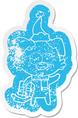 nervous dog cartoon distressed sticker of a with gift wearing santa hat