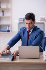Young male employee working in the office