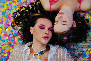 Two friends wearing makeup with eyes closed