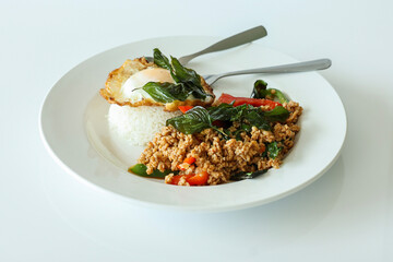 Pad Kra Pow with chicken in bowl with rice and fried thai basil - obrazy, fototapety, plakaty