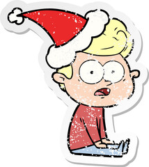 distressed sticker cartoon of a staring man wearing santa hat