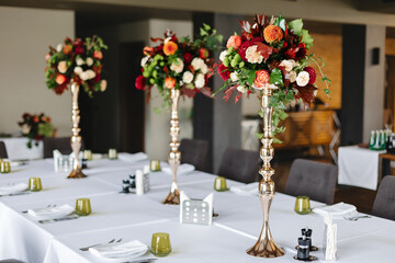 A table set in a restaurant with an arrangement of flowers.
