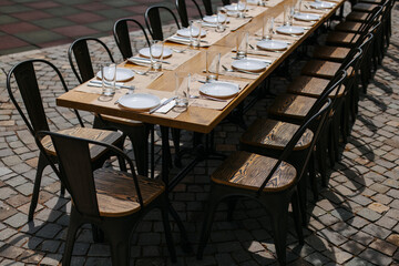 A large table was set on the street near a house outside the city.