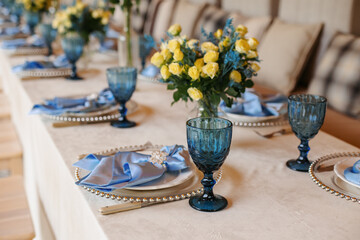 A table is set in a wooden gazebo near a house outside the city. Birthday decor.